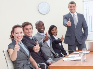 Businessteam With Thumbs Up After A Presentation